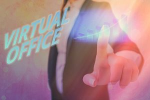 Text sign showing Virtual Office over a sunset colored image of a man in a suit touching the screen and dragging an arrow upward. Image licensed through Adobe Stock.. 