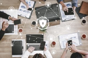 Photo of various devices including laptops and phones with a graphic overlay of white lines and markers for security. Image licensed through Adobe Stock.