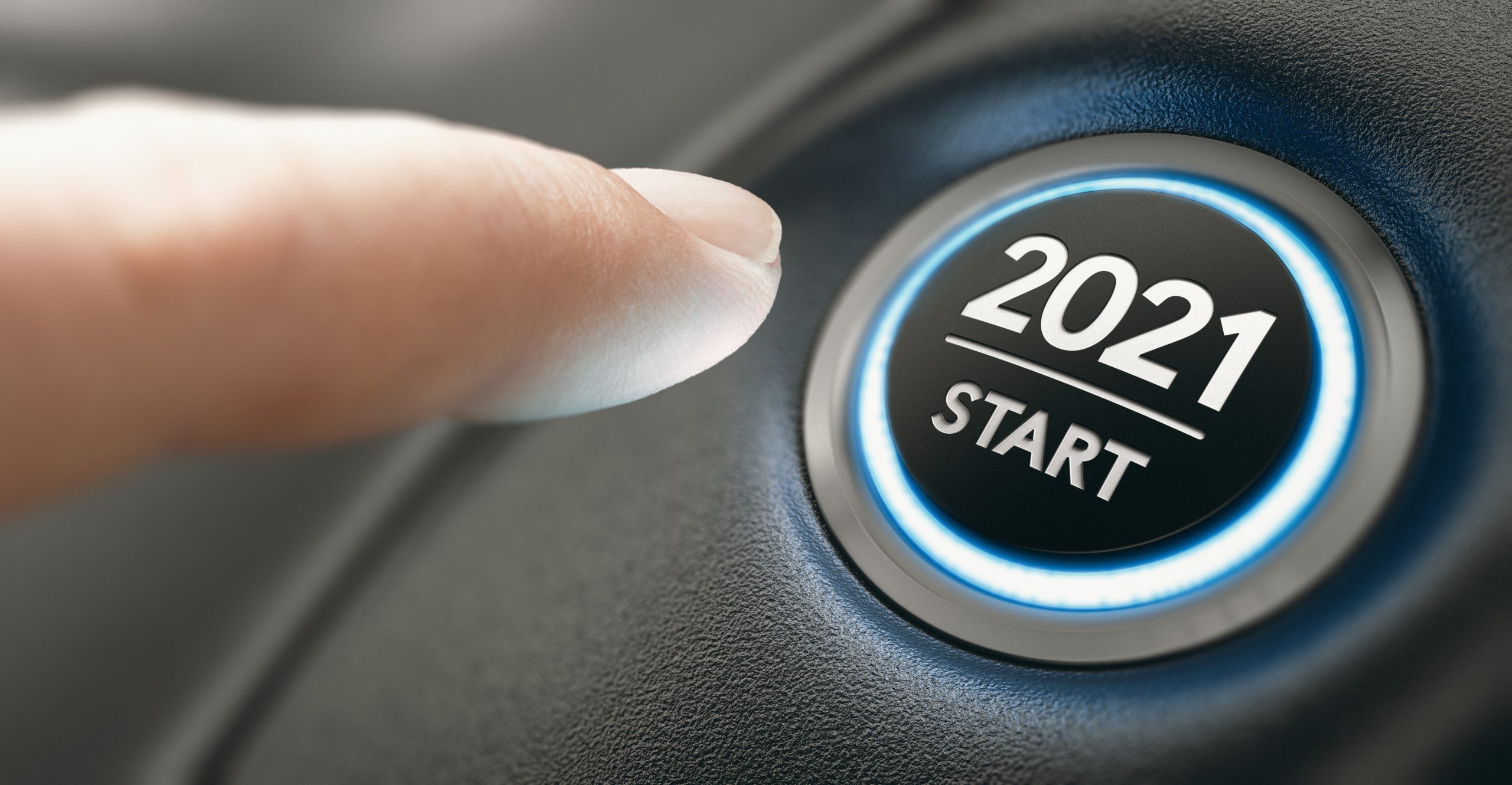 Finger about to press a car ignition button with the text 2021 start. Licensed through Adobe Stock.