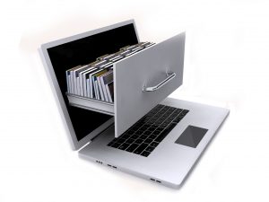 A laptop with a file drawer being pulled out of it. Licensed through Adobe Stock.