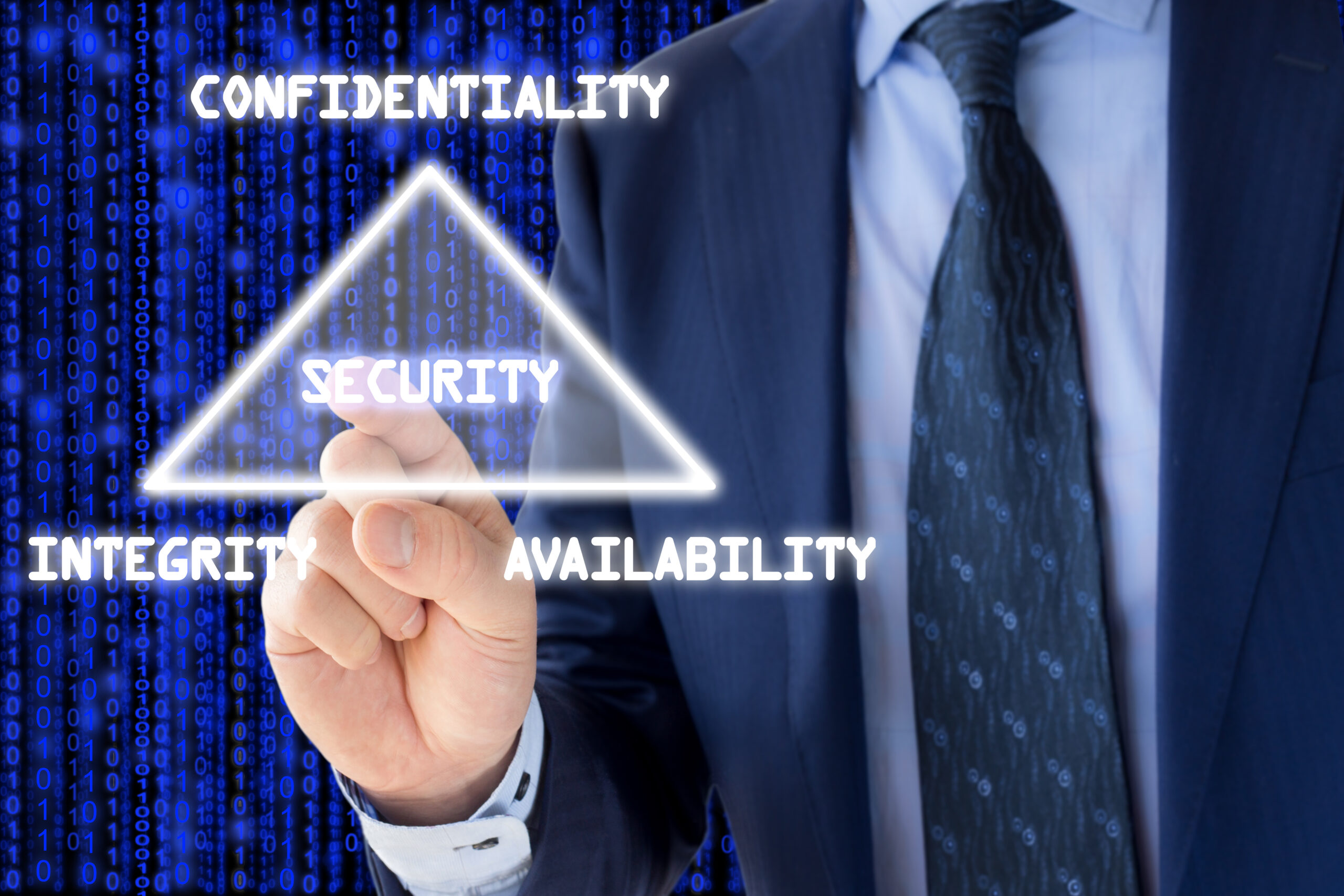 The basic concept of information security the CIA triangle illustrated by an IT expert on blue. A white person in a navy suit is in front of a blue stylized background with an overlay that the person is pointing to of a white glowing triangle with the text "security" inside the triangle and the words "confidentiality", "integrity", and "availability" on the points.
