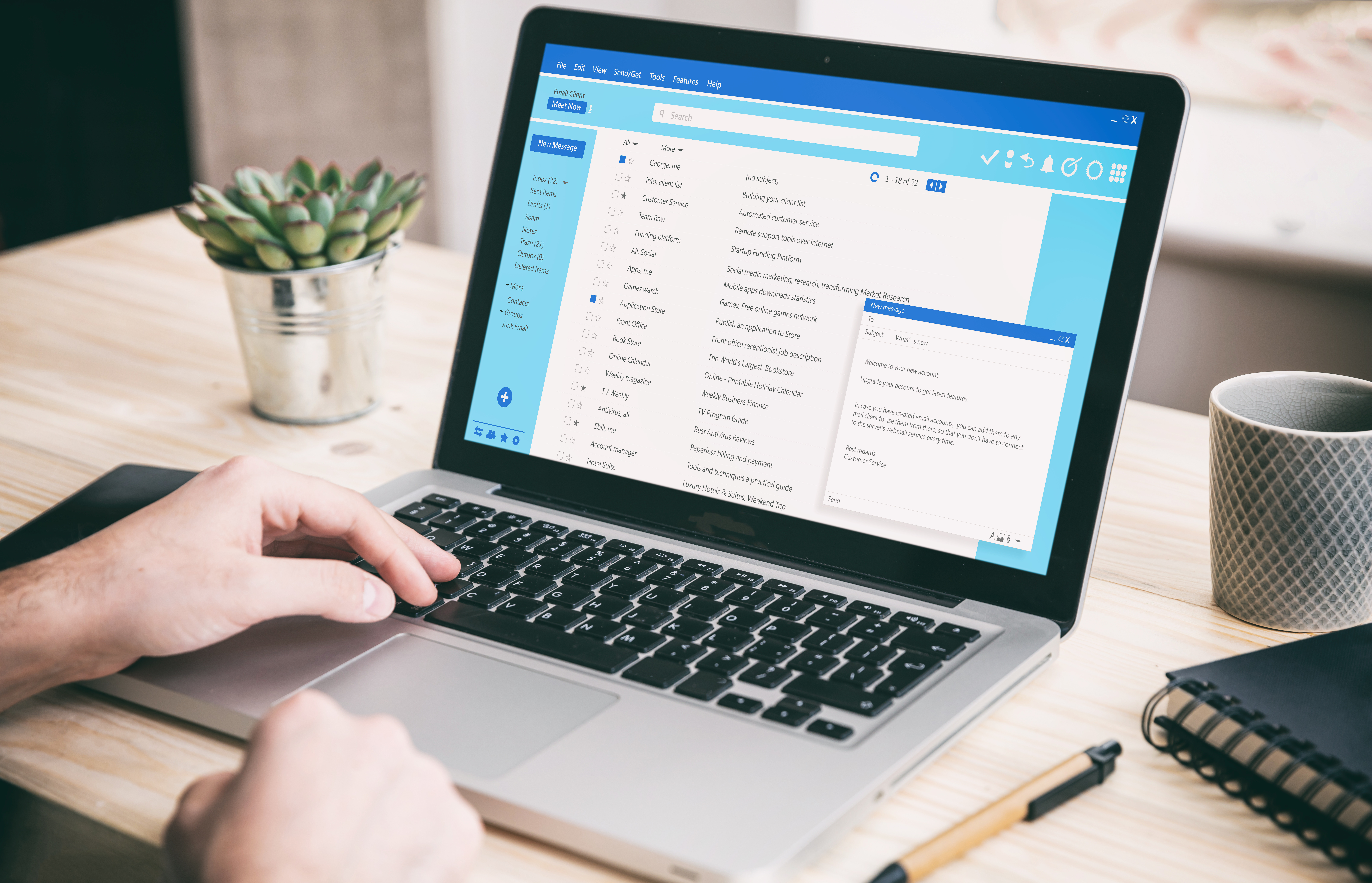 Image over the shoulder of a man working with a computer, client mail list on laptop screen, with an office desk in the background. Image licensed through Adobe Stock.